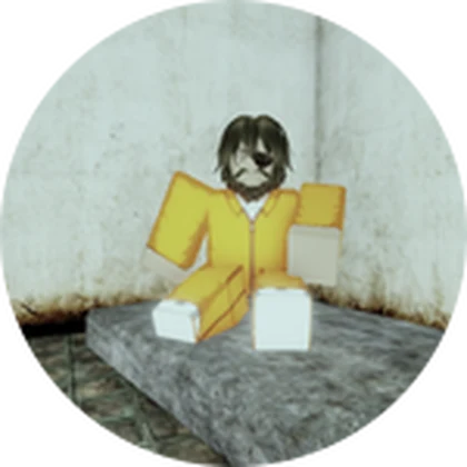 Marlow sitting against a prison wall